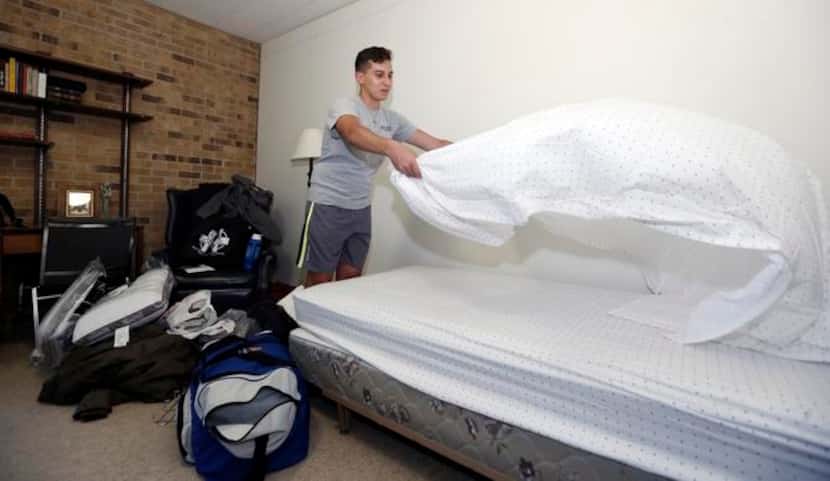 
Pre-theology student Ivan Torres makes his bed during move-in day at Holy Trinity Seminary...