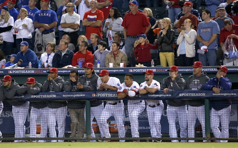 Texas Rangers players and fans watch David Murphy's fly ball being caught to end the Rangers...