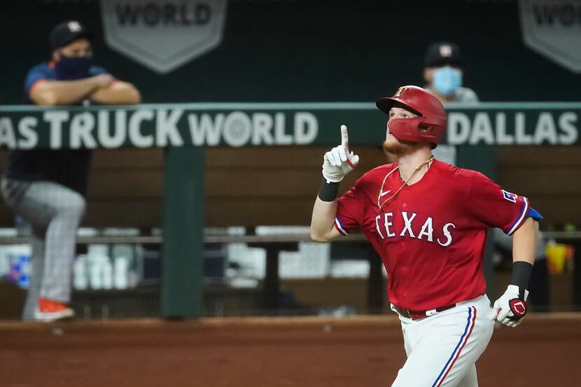 Texas Rangers catcher Sam Huff celebrates as he rounds the bases after hitting a solo home...