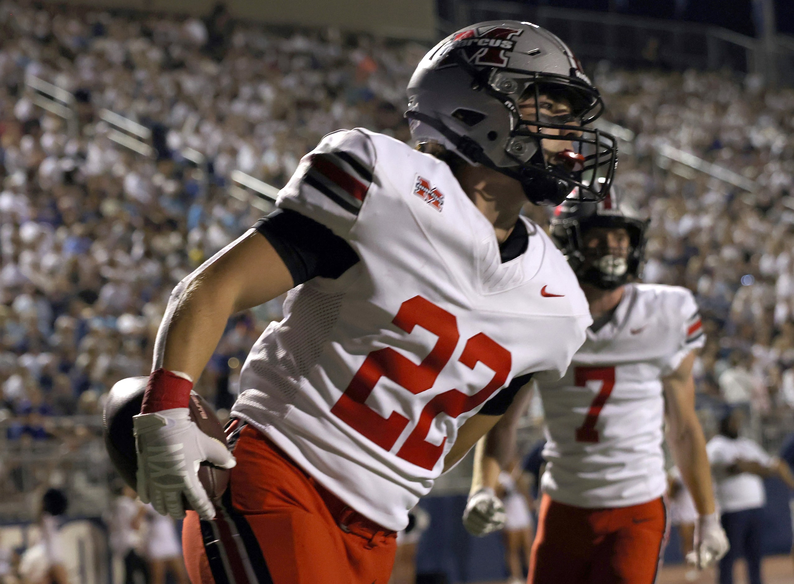 Flower Mound Marcus running back Mason Jones (22) runs through the end zone after scoring a...