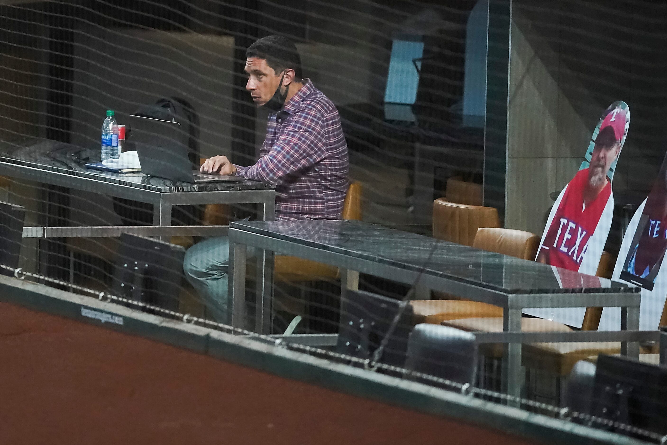 Texas Rangers general manager Jon Daniels watches from behind home plate during the first...