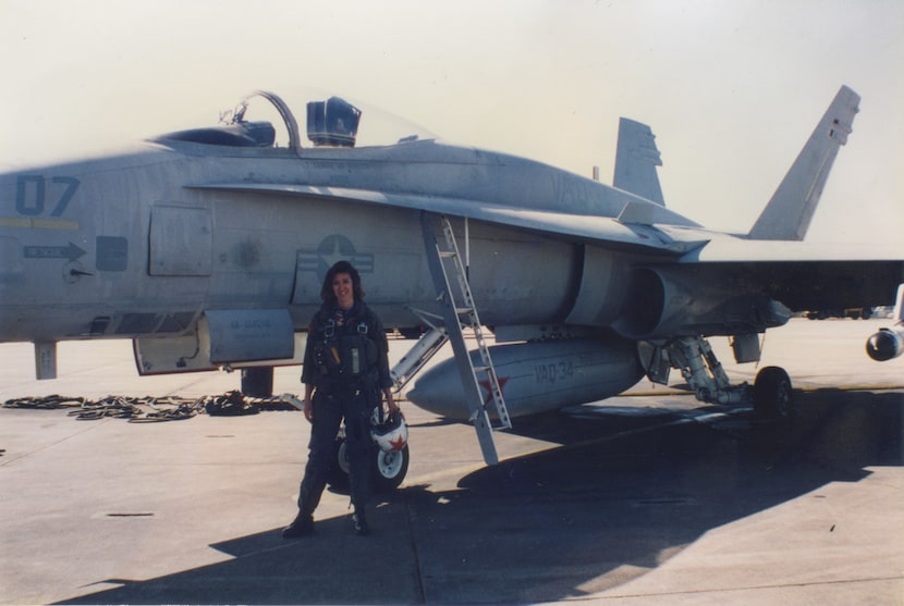 Pilot Tammie Jo Shults in front of a Navy jet.