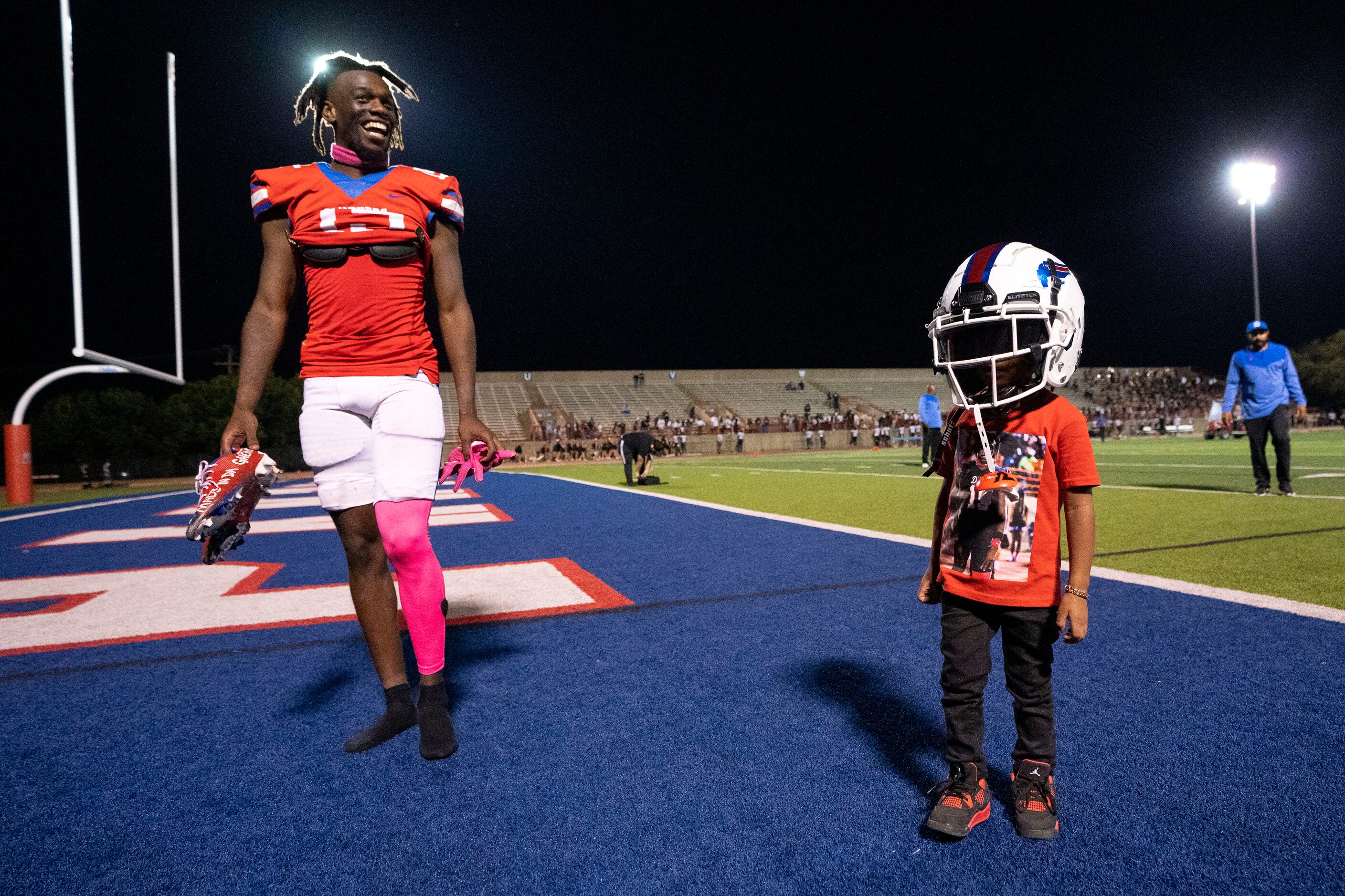 Duncanville senior defensive back Lamoderick Spencer (15) laughs as his 3-year-old brother...