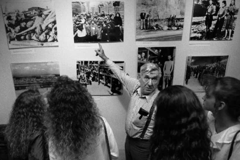 Holocaust survivor Michael Jacobs  shows historical photos of the concentration camps at the...