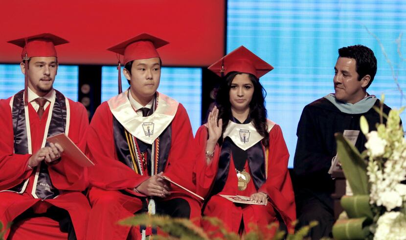 Prior to delivering her speech, Valedictorian Larissa Yanin Martinez waves to the crowd as...