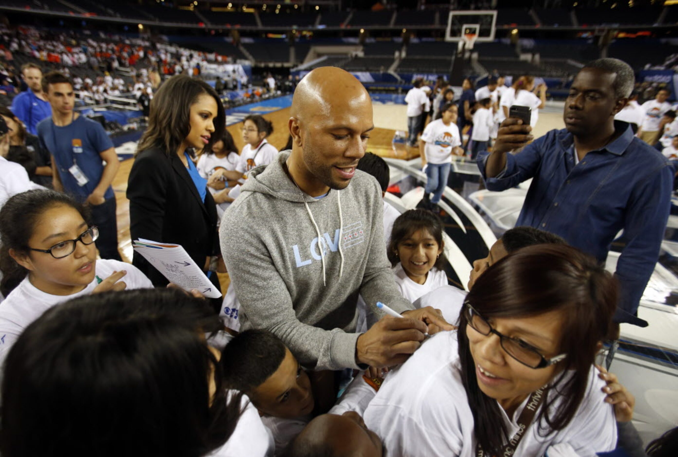 Recording artist and actor Common (Lonnie Rashid Lynn, Jr.) gives out autographs to kids...