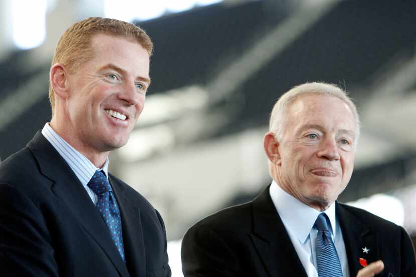 New Dallas Cowboys head coach Jason Garrett smiles next to owner and general manager Jerry...