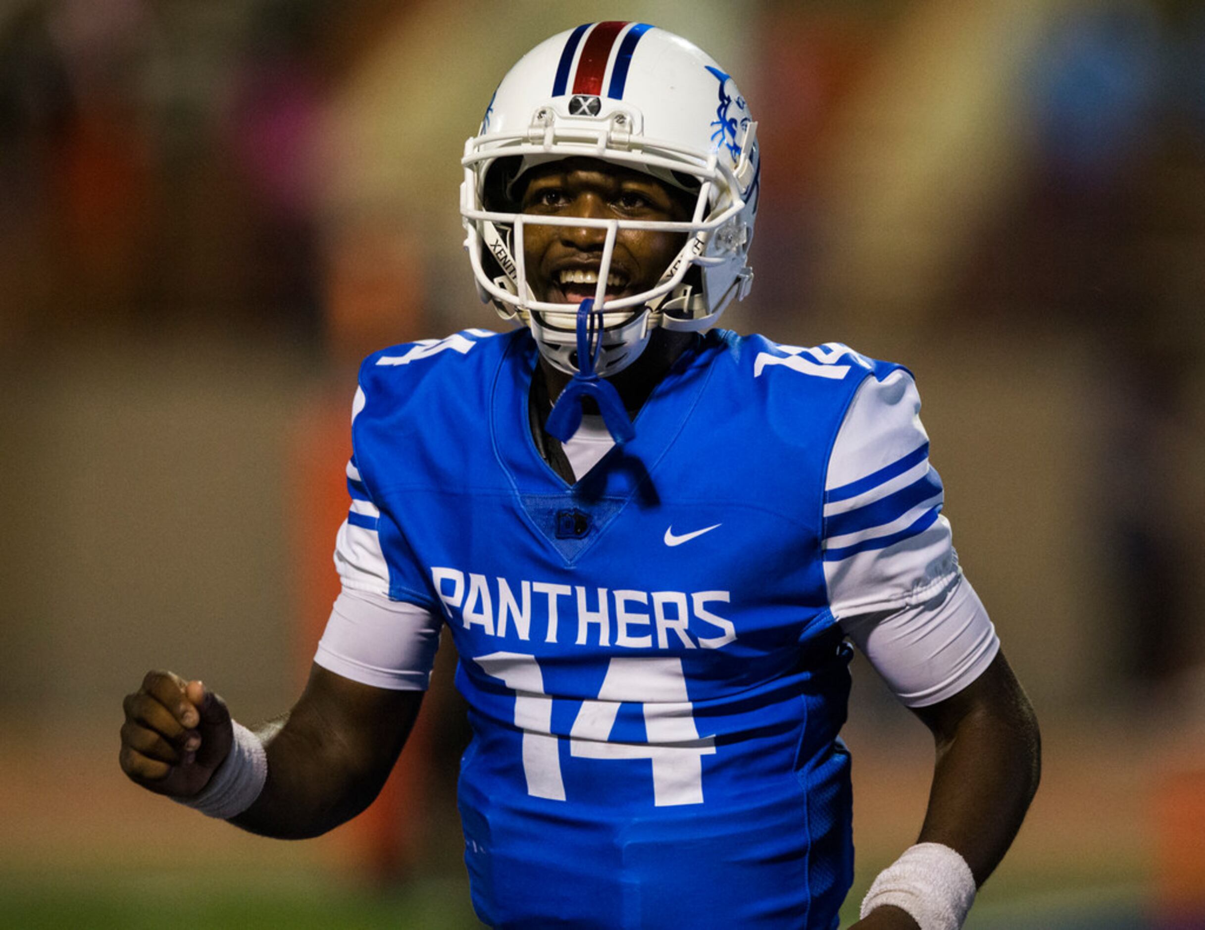 Duncanville quarterback Chris Parson (14) smiles after scoring a touchdown during the fourth...