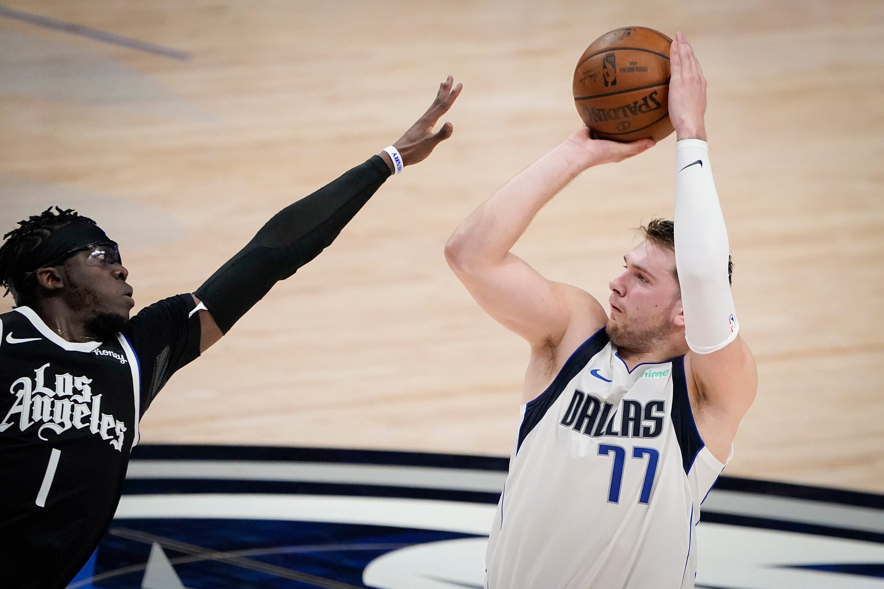 Dallas Mavericks guard Luka Doncic (77) shoots over LA Clippers guard Reggie Jackson (1)...