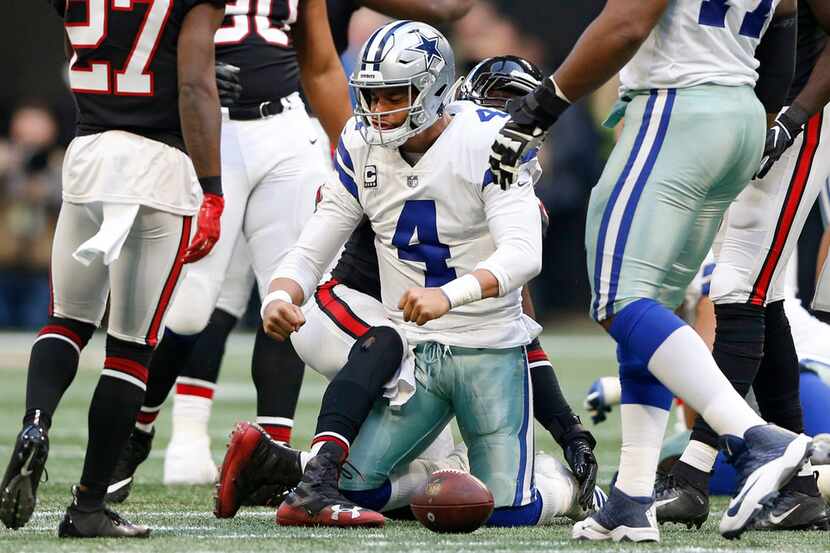 Dallas Cowboys quarterback Dak Prescott (4) flexes after making a first down on a run during...