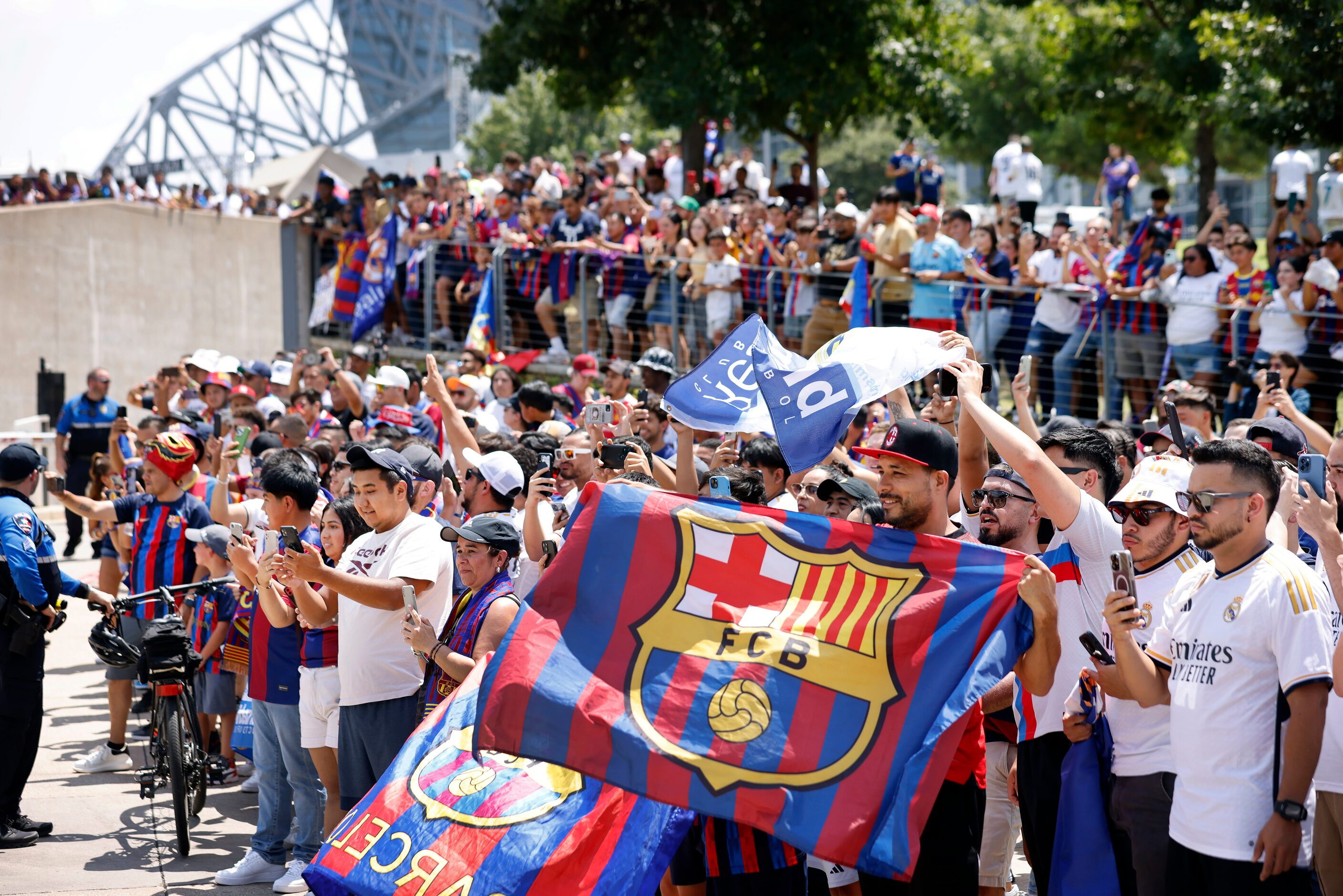 Barcelona soccer fans cheer as their team buses arrive for a Soccer Champions Tour futbol...