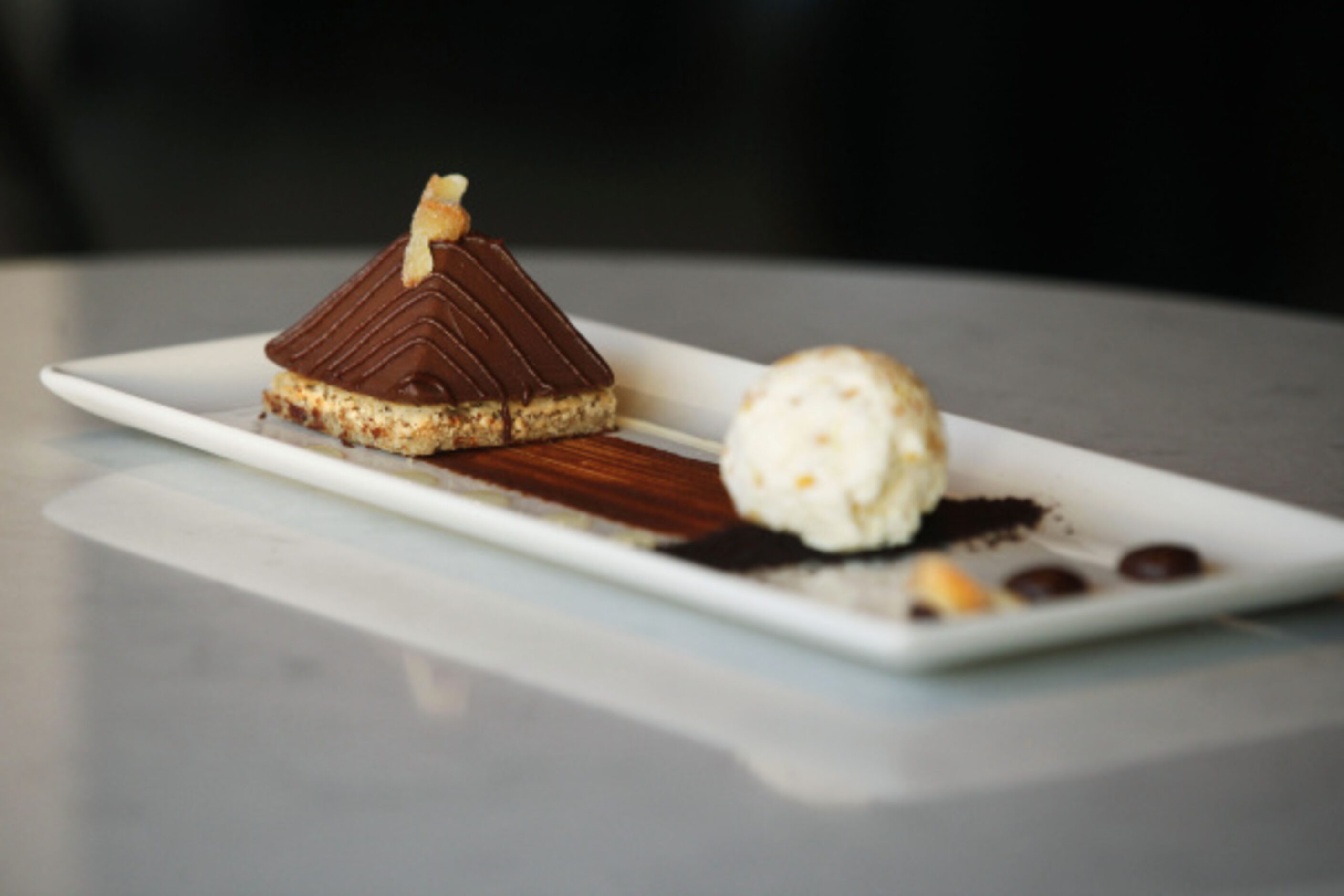 Gianduja (chocolate-hazelnut) panna cotta is set atop a hazelnut blondie and served with...