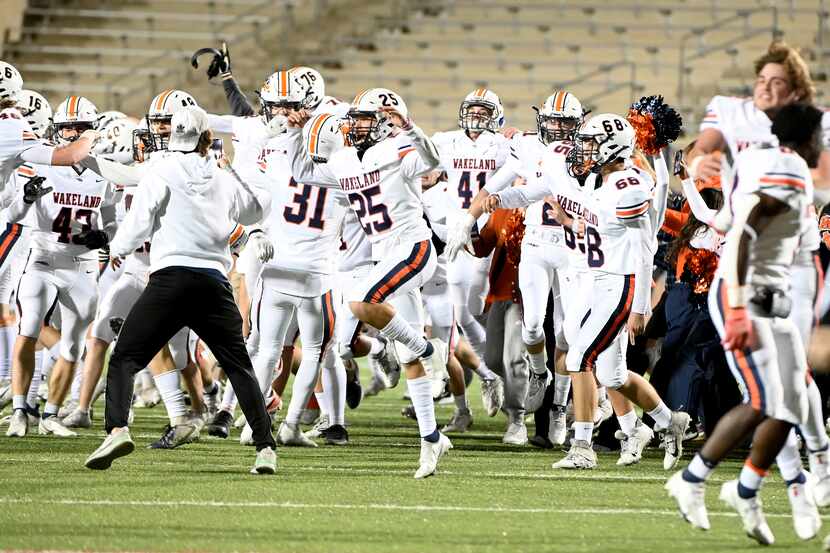 Wakeland players run onto the field after their 29-28 win of a Class 5A Division I...