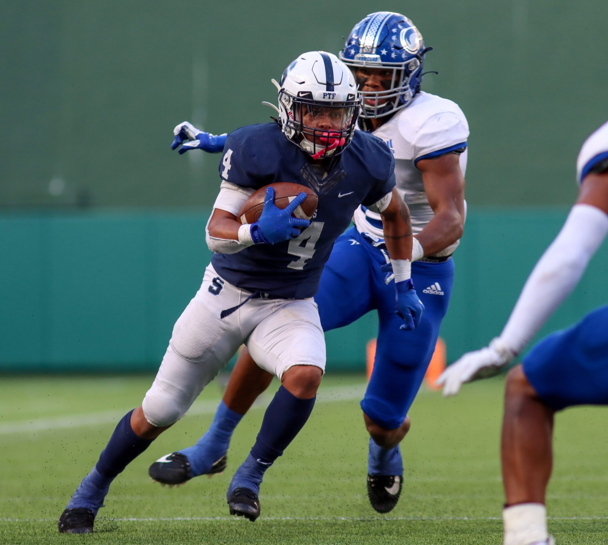 Fort Worth Nolan outside linebacker Vincent Paige (2) pursues Fort Worth All Saints running...