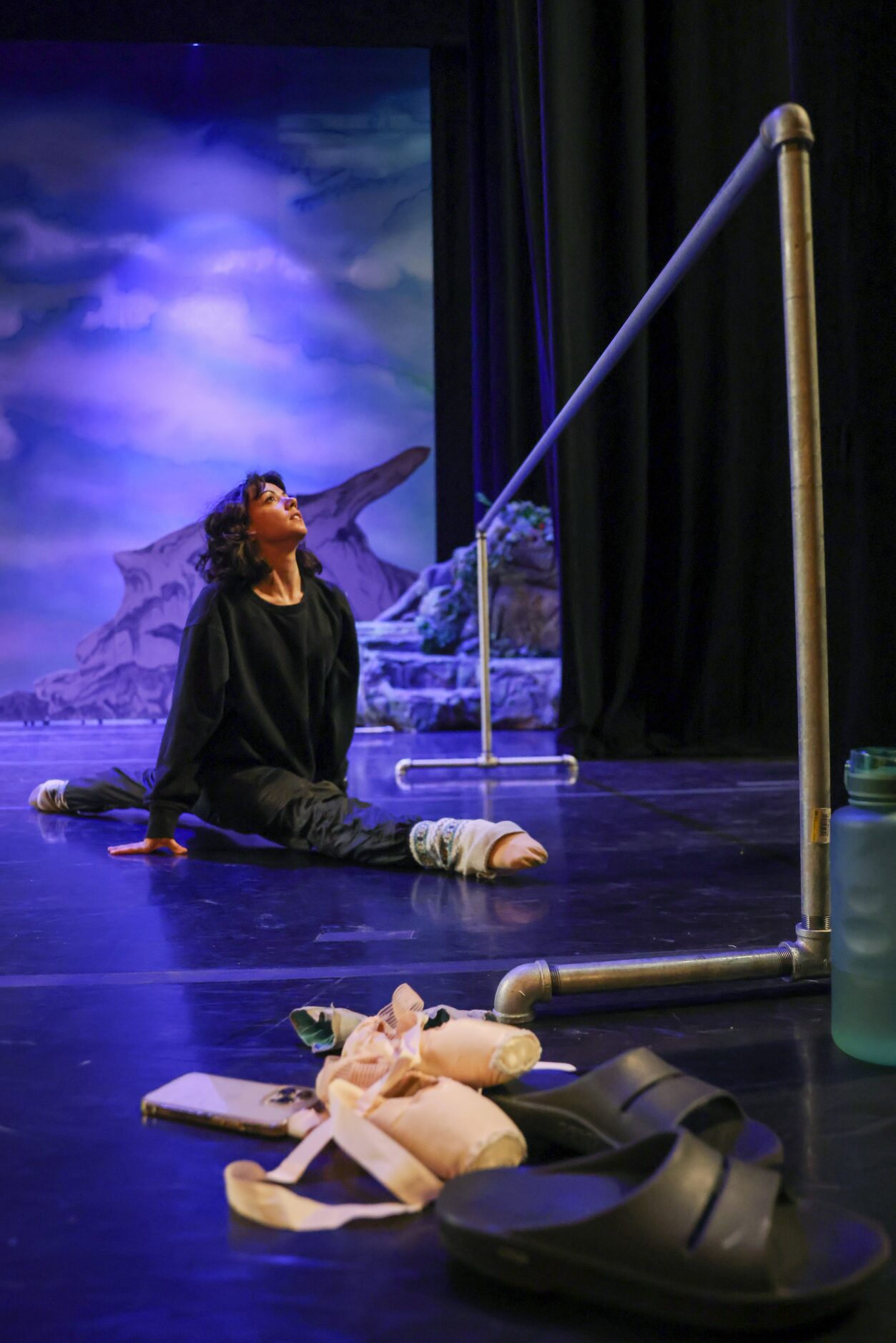 Alexandra F. Light warms up on an empty stage for her role as Alice in a dress rehearsal of...