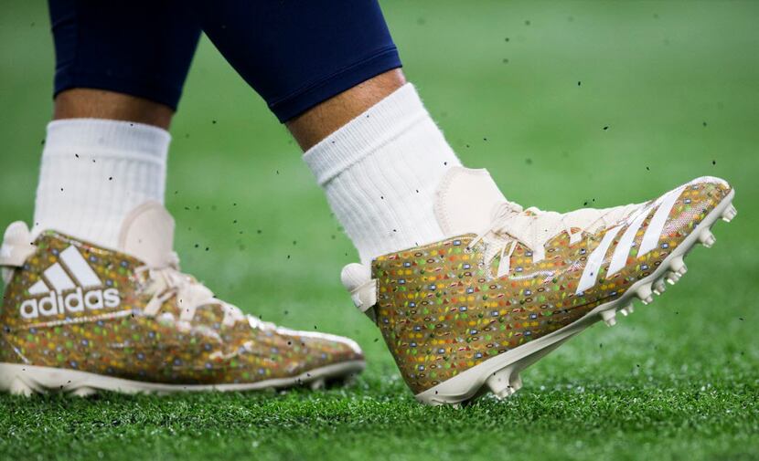 Dallas Cowboys quarterback Dak Prescott (4) wears custom Thanksgiving cleats as he warms up...