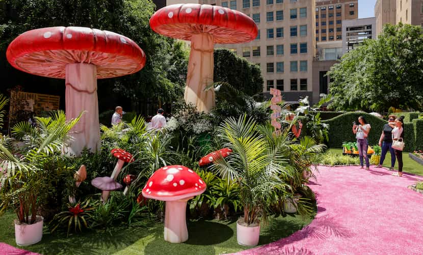 Visitors take in the Eyeboretum's garden, including its huge mushrooms, on Friday, the first...