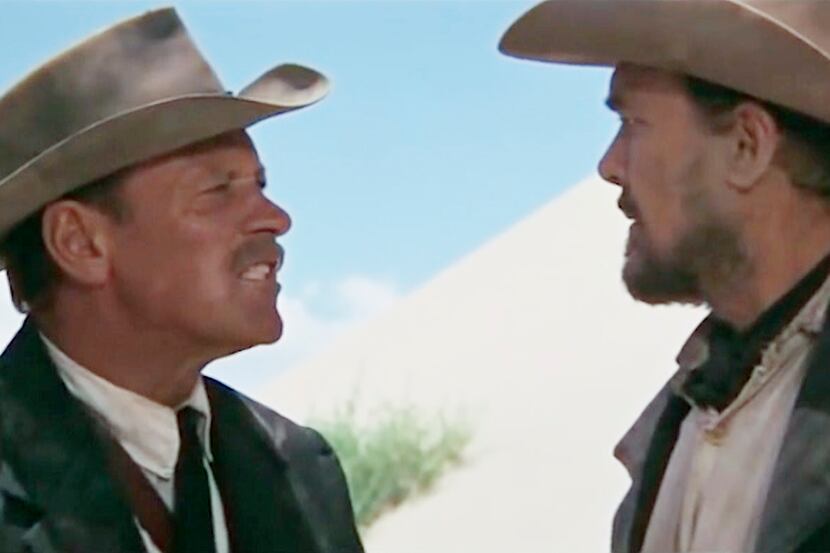 William Holden and Ben Johnson have a word in "The Wild Bunch."