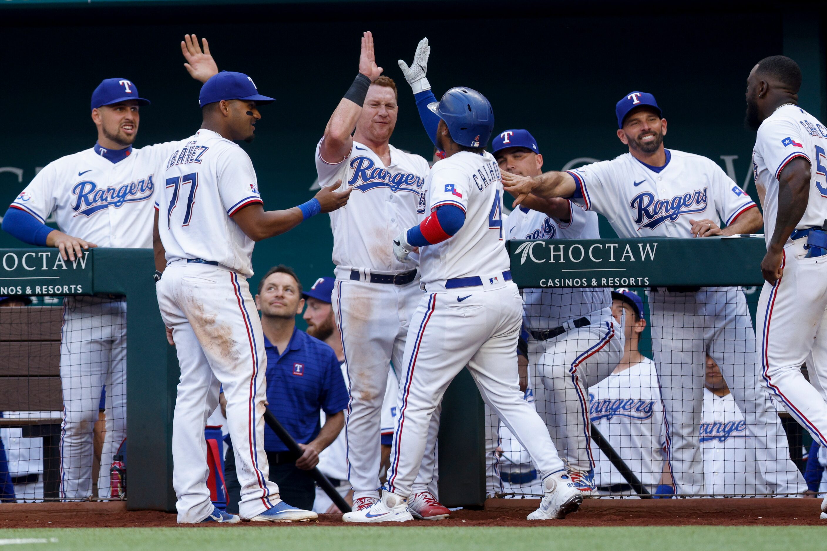 Texas Rangers left fielder Willie Calhoun (4) celebrates his game-tying home run with...