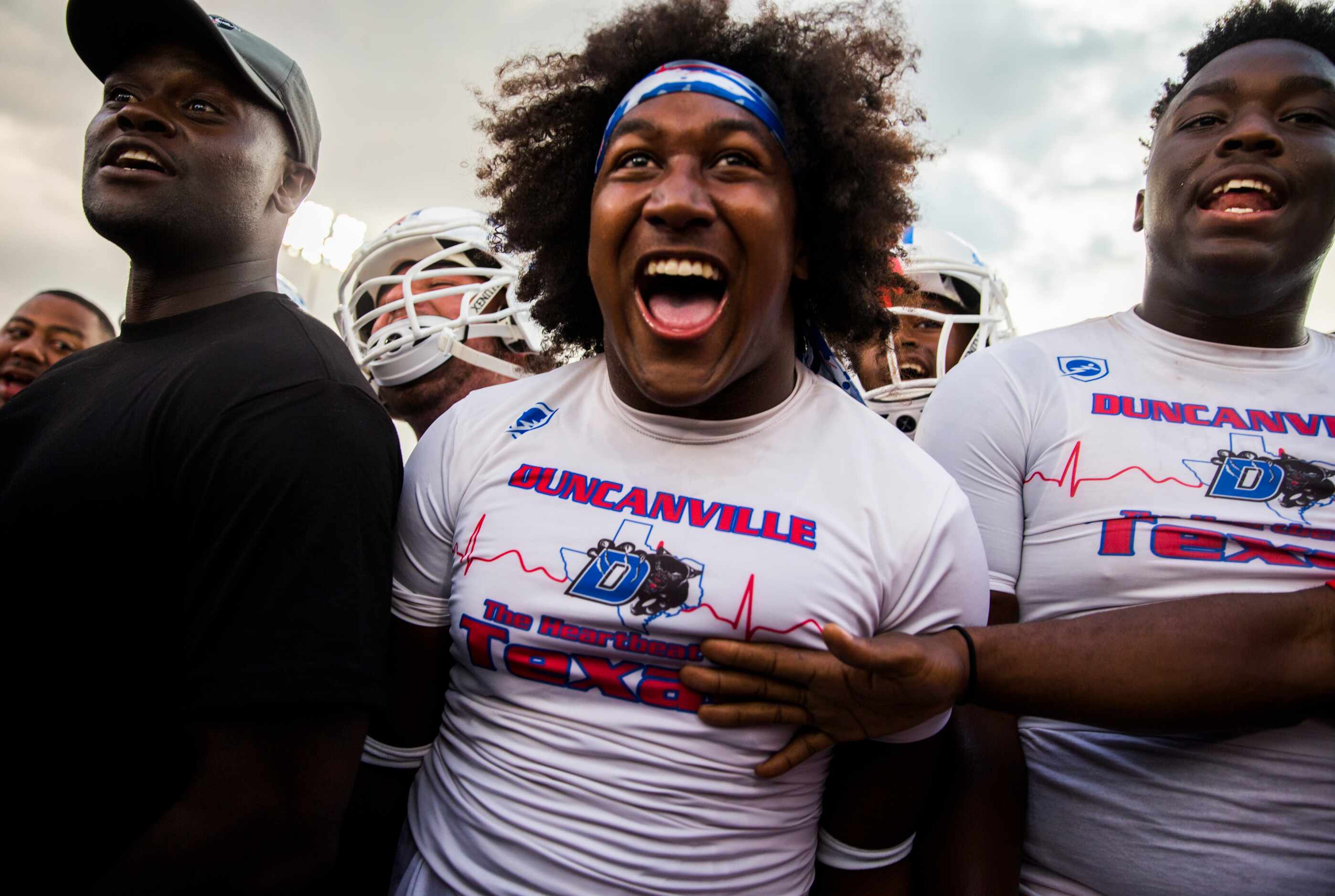 Duncanville linebacker Amari Wynn (52, center) and other players trash talk before a high...