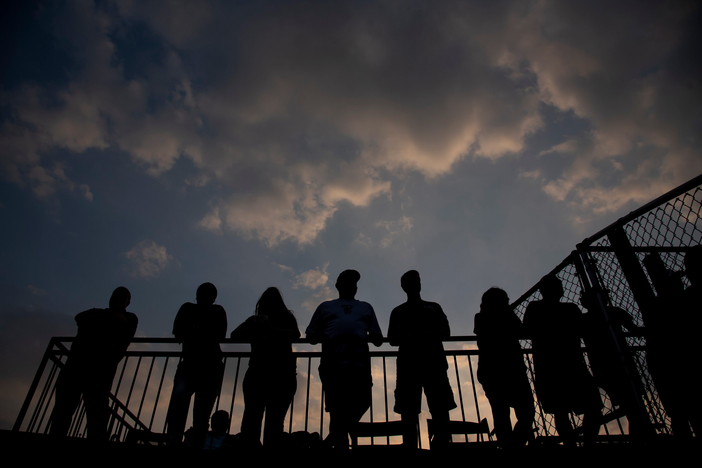 The sun sets behind fans as they enjoy game two of the Class 5A Softball Region II semifinal...