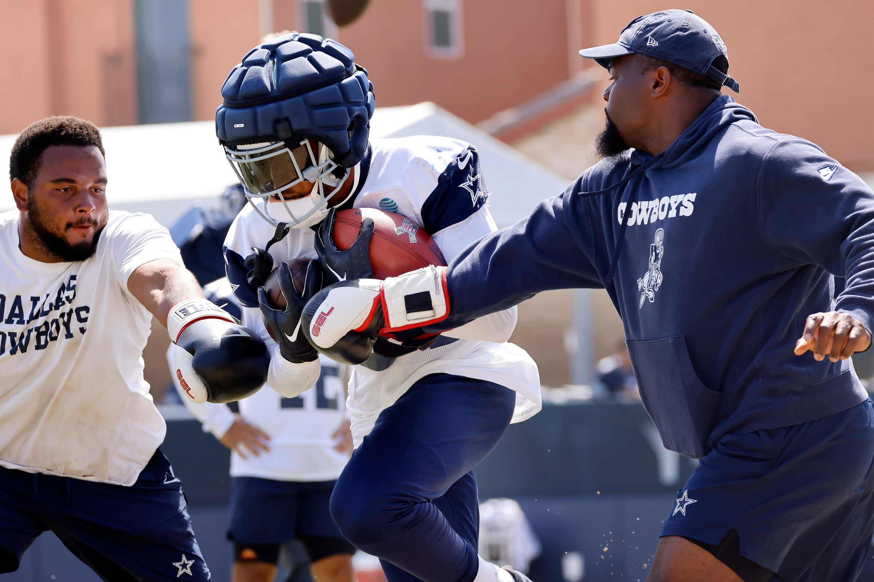 Dallas Cowboys running back Malik Davis (34) is pounded with boxing gloves during a training...