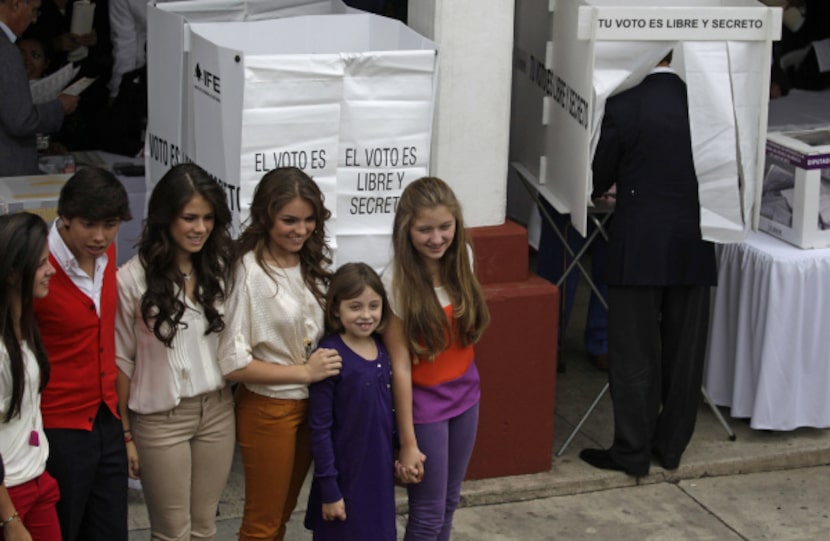 While Enrique Peña Nieto marked his ballot in this month's election, his children posed for...