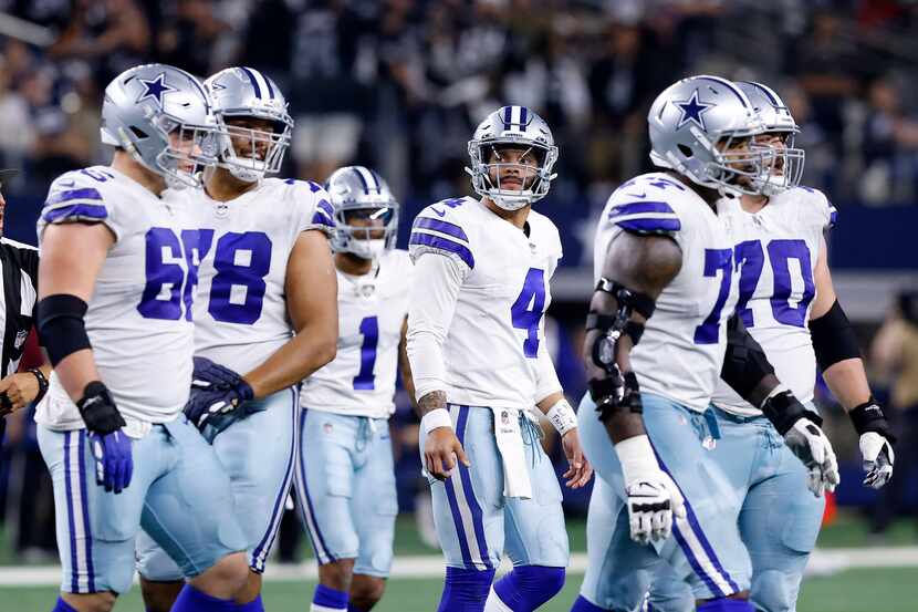 Dallas Cowboys quarterback Dak Prescott (4) and the offense walk off the field after being...