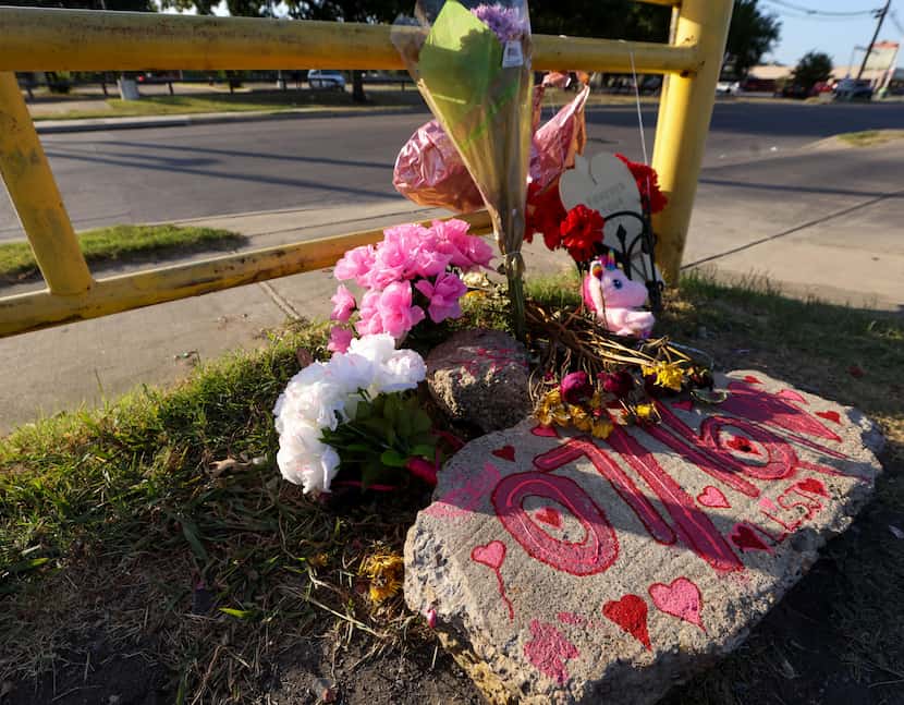 A rock, painted with the date when Shaniah Jones, 24, was fatally shot last week, sits in a...