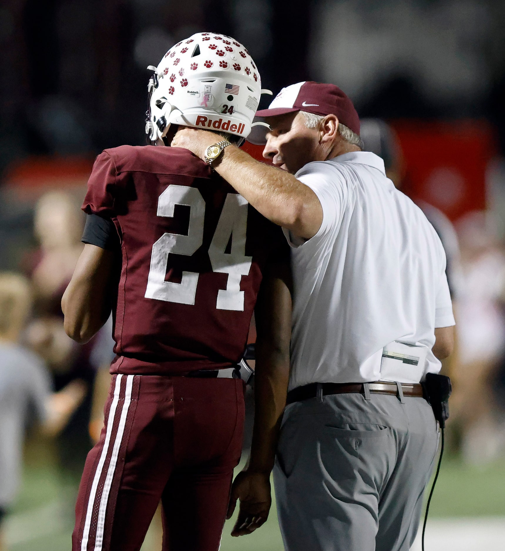 Plano High head coach Cody White puts his arm around his starting quarterback Tyree Fisher...