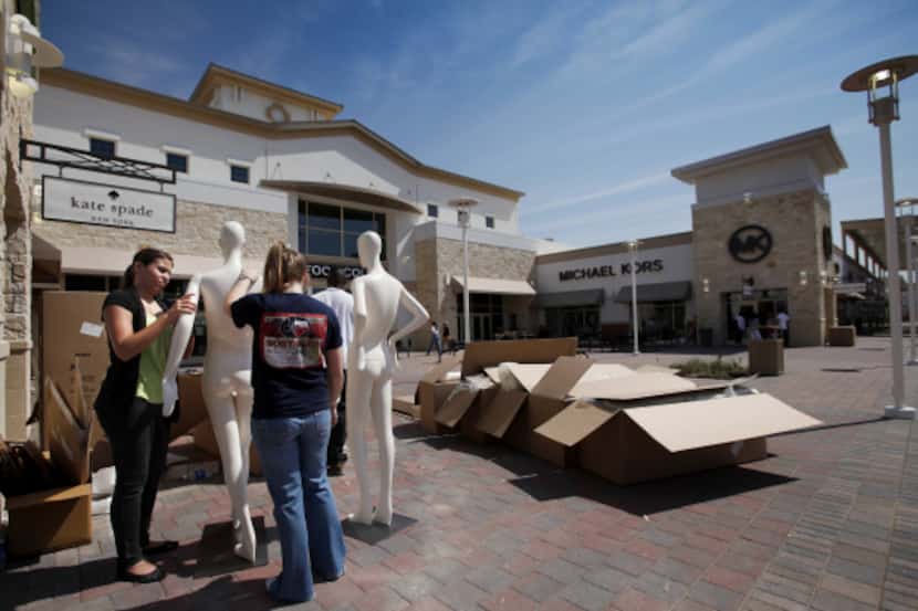In this 2012 file photo, Tiffany Sola and Kelsey Blum assemble mannequins outside of the...
