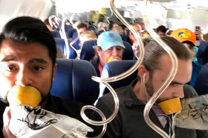 Marty Martinez,  left, appears with other passengers after a jet engine blew out on the...