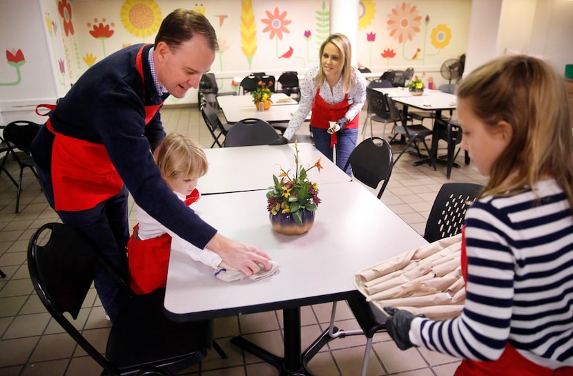 Meredith Land, husband Xan and children Alexander and McCall help set the table for lunch at...