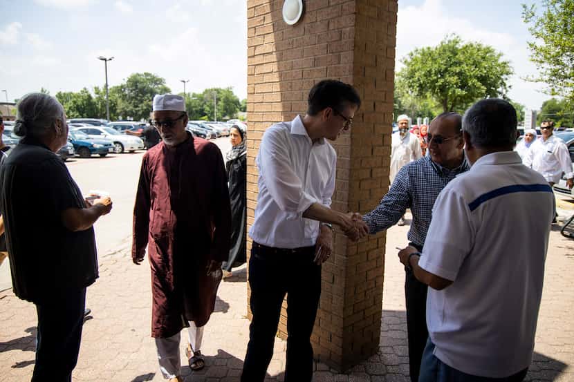Scott Griggs shakes hands with worshippers at the Islamic Association of North Texas mosque...