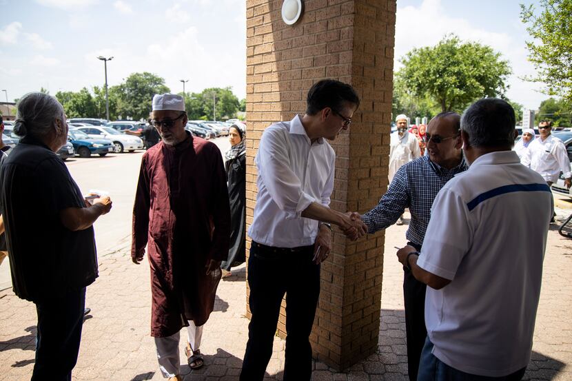 Scott Griggs shakes hands with worshippers at the Islamic Association of North Texas mosque...