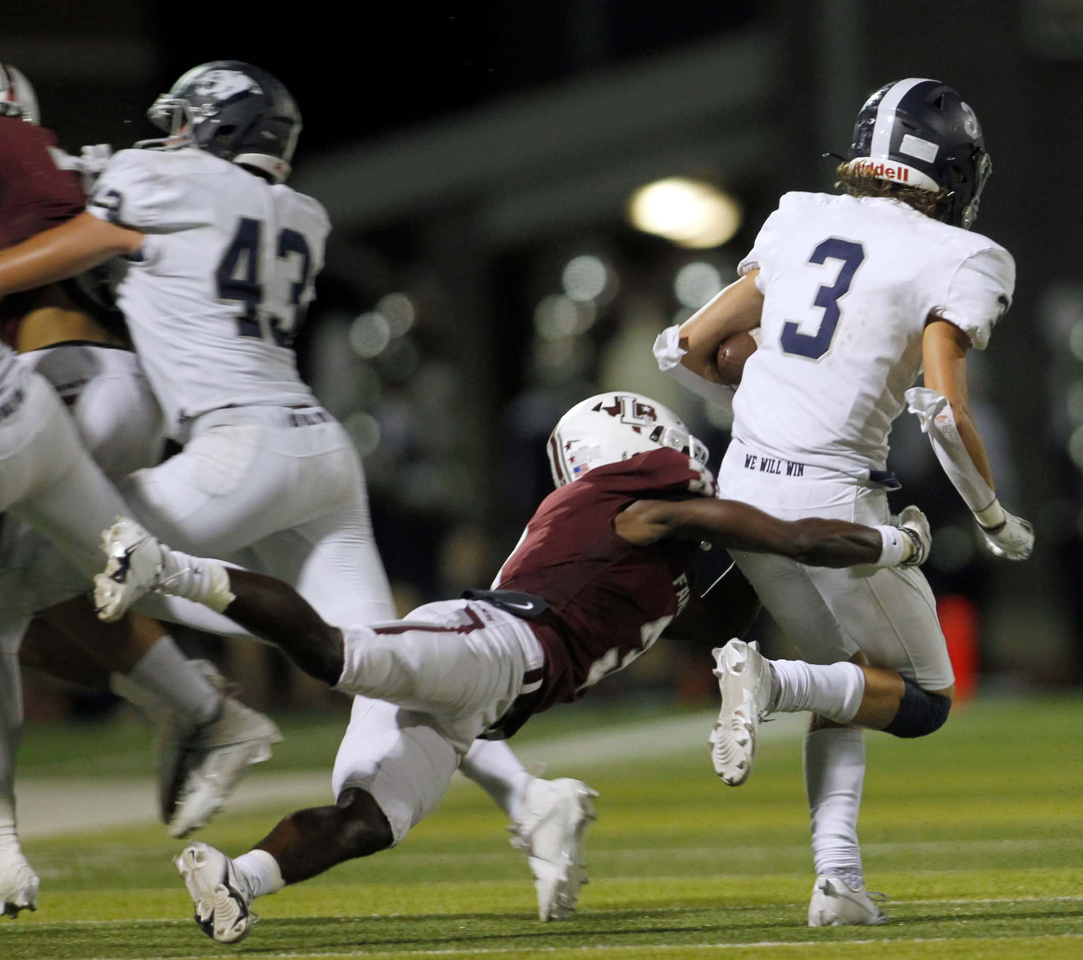 Flower Mound cornerback Mason MacDonald (3), right, is tackled by Lewisville receiver Tye...