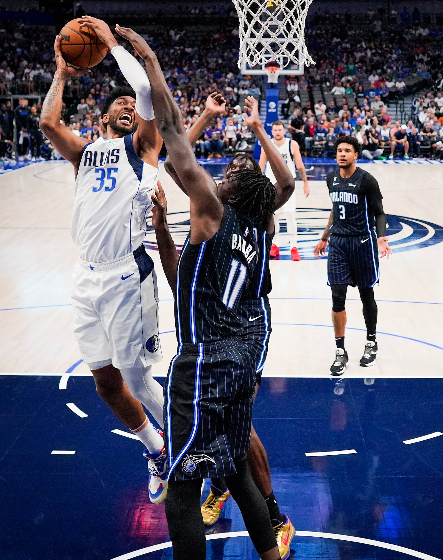 Dallas Mavericks center Christian Wood (35) shoots over Orlando Magic center Mo Bamba (11)...