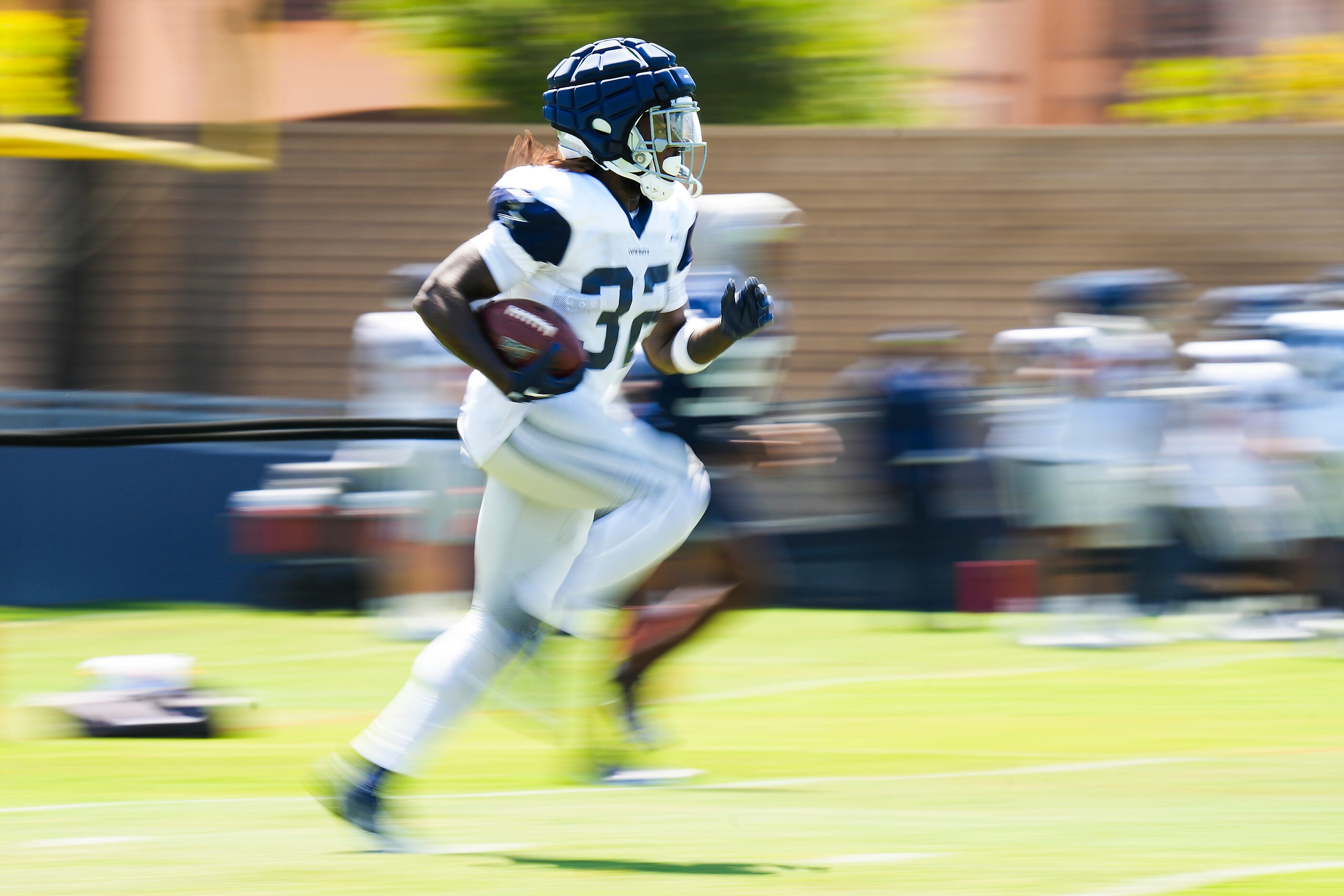 Dallas Cowboys running back Ronald Jones (32) returns a punt during a training camp practice...