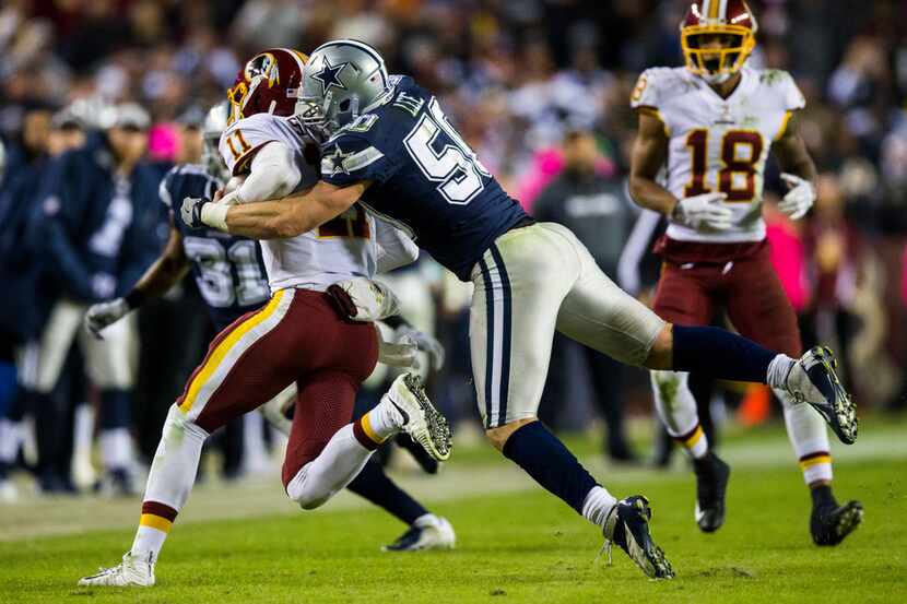 Dallas Cowboys linebacker Sean Lee (50) tackles Washington Redskins quarterback Alex Smith...