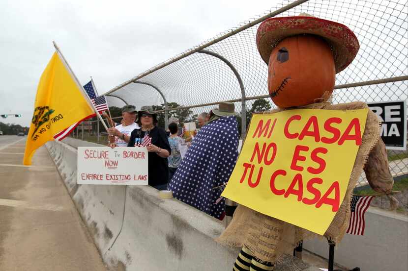 Protesters line the overpass during a protest against people who immigrate illegally,  July...