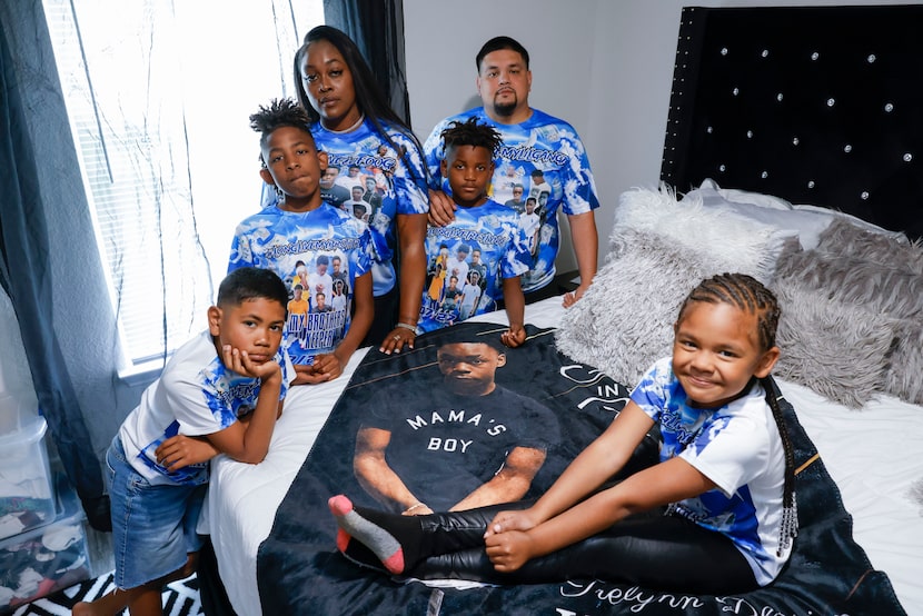 Yadira Campbell (center) alongside her kids and partner Jose Garcia, pose by a blanket...