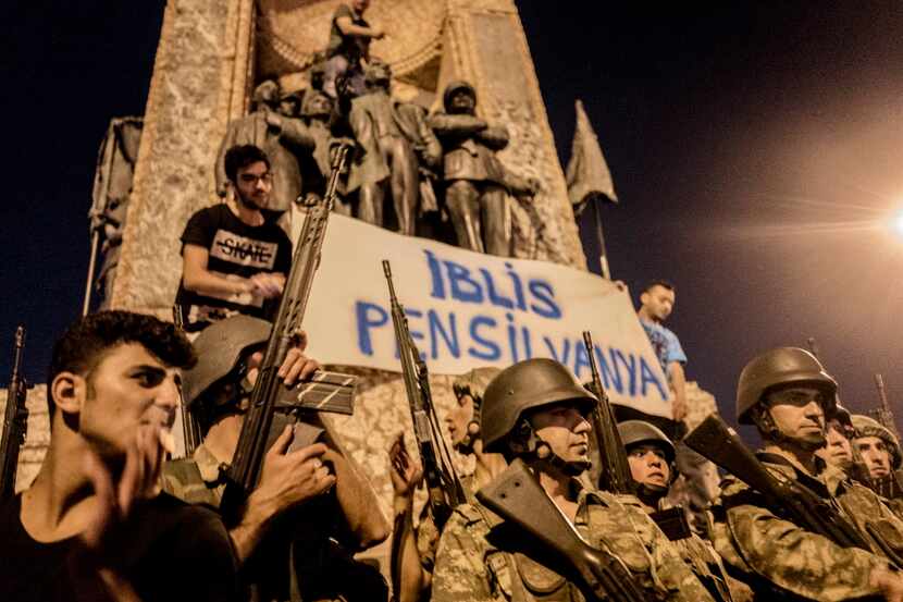Turkish soldiers stand by as demonstrators held a banner reading "Demon Pennsylvania" on the...
