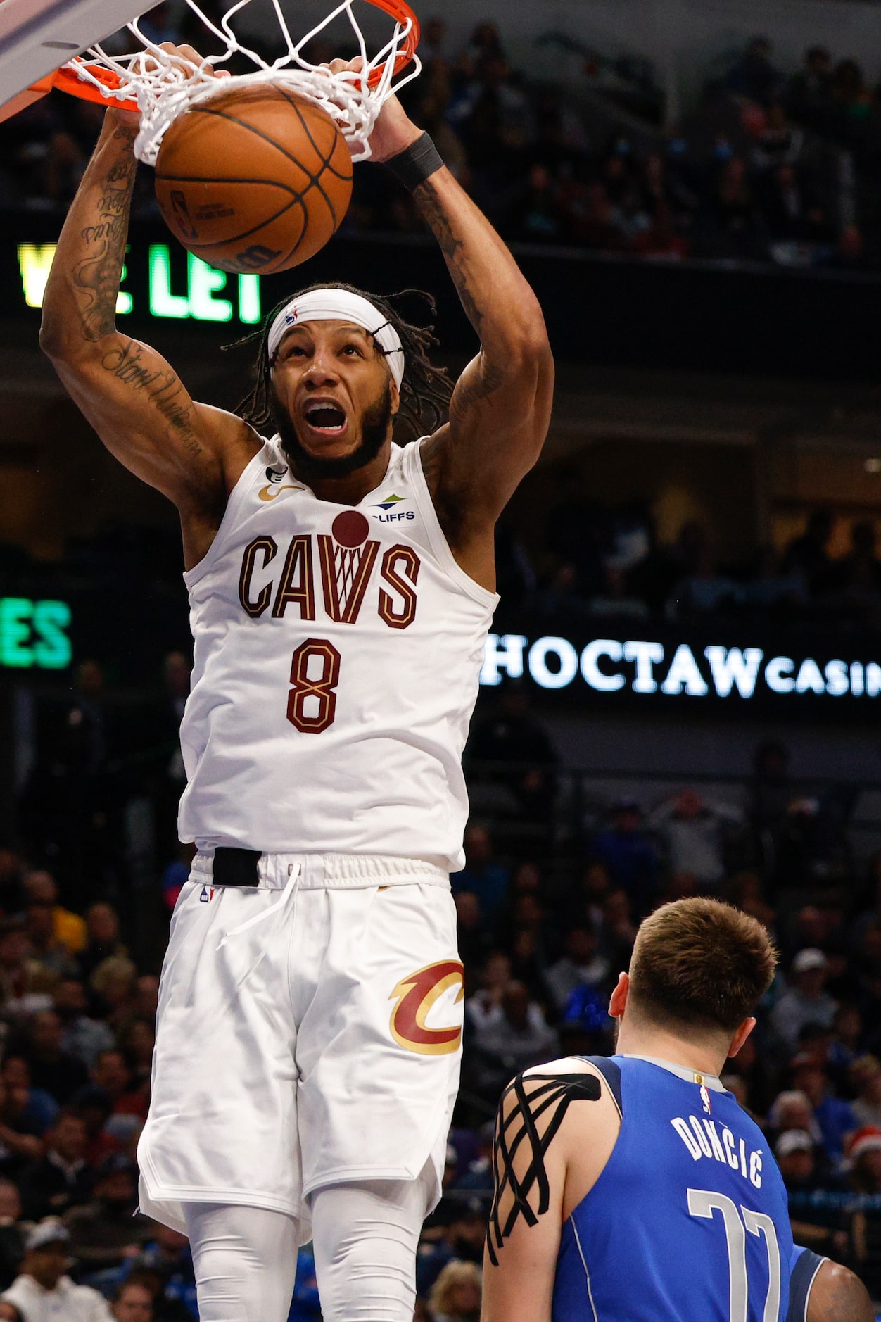 Cleveland Cavaliers forward Lamar Stevens (8) dunks the ball alongside Dallas Mavericks...