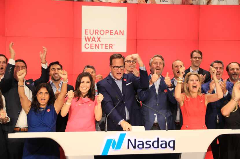 Plano-based European Wax Center CEO David Berg (center) celebrates the start of trading for...