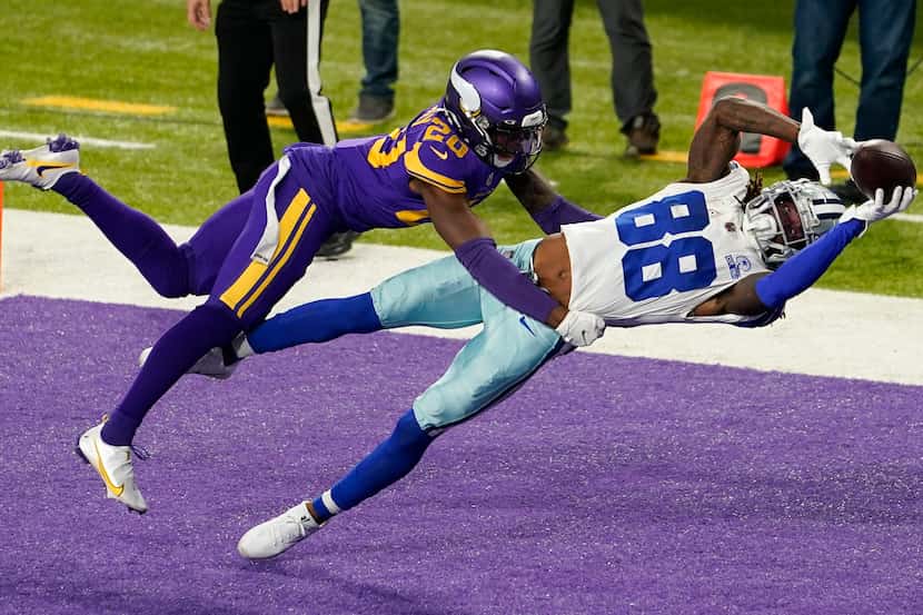 Dallas Cowboys wide receiver CeeDee Lamb catches a 4-yard touchdown pass ahead of Minnesota...