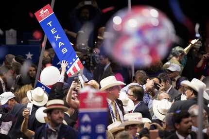 Members of the Texas delegation take down their state sign at the conclusion of the...