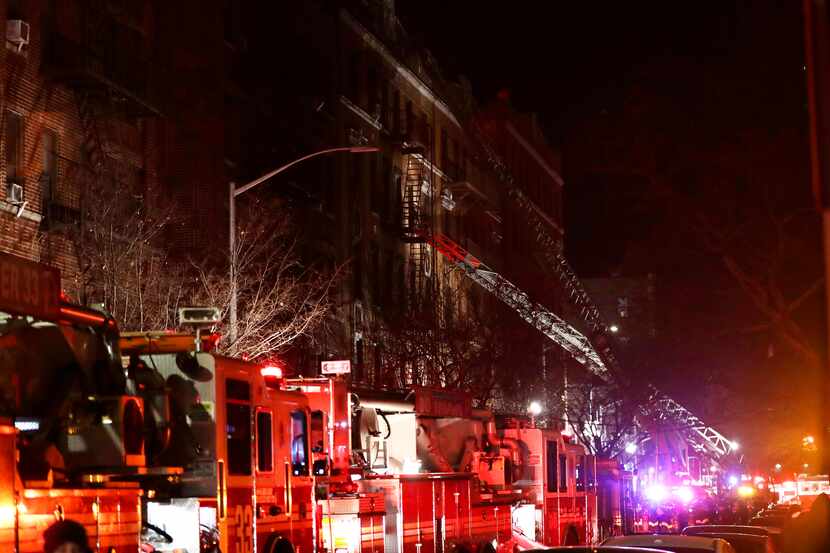 Firefighters respond to a building fire Thursday, Dec. 28, 2017, in the Bronx borough of New...