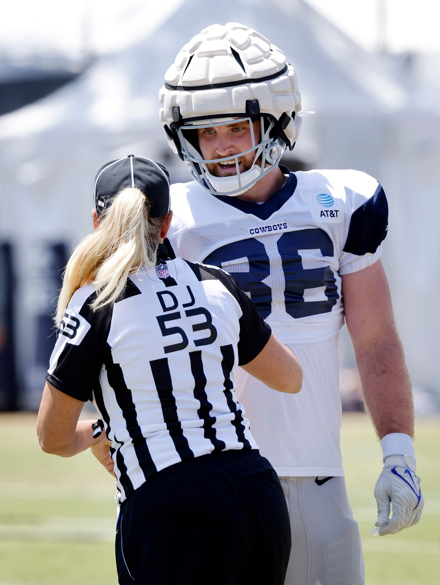 Dallas Cowboys tight end Dalton Schultz (86) contests a call by down judge Sarah Thomas (53)...