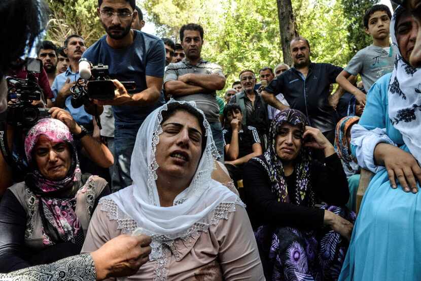 Women cry during a funeral  for a victim of last night's attack on a wedding party that left...