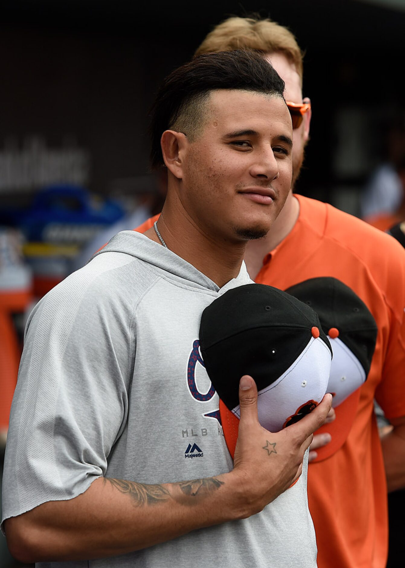 Baltimore Orioles' Manny Machado pauses for the singing of God Bless America in the seventh...